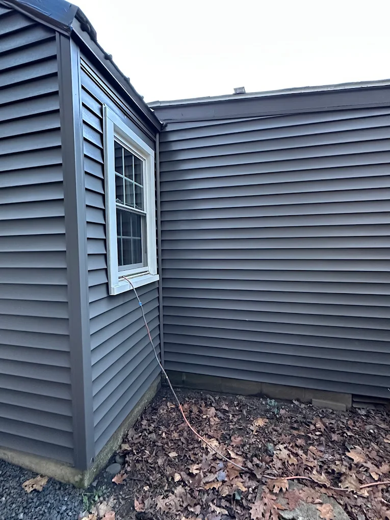 Close view of evenly finished charcoal gray siding and trim