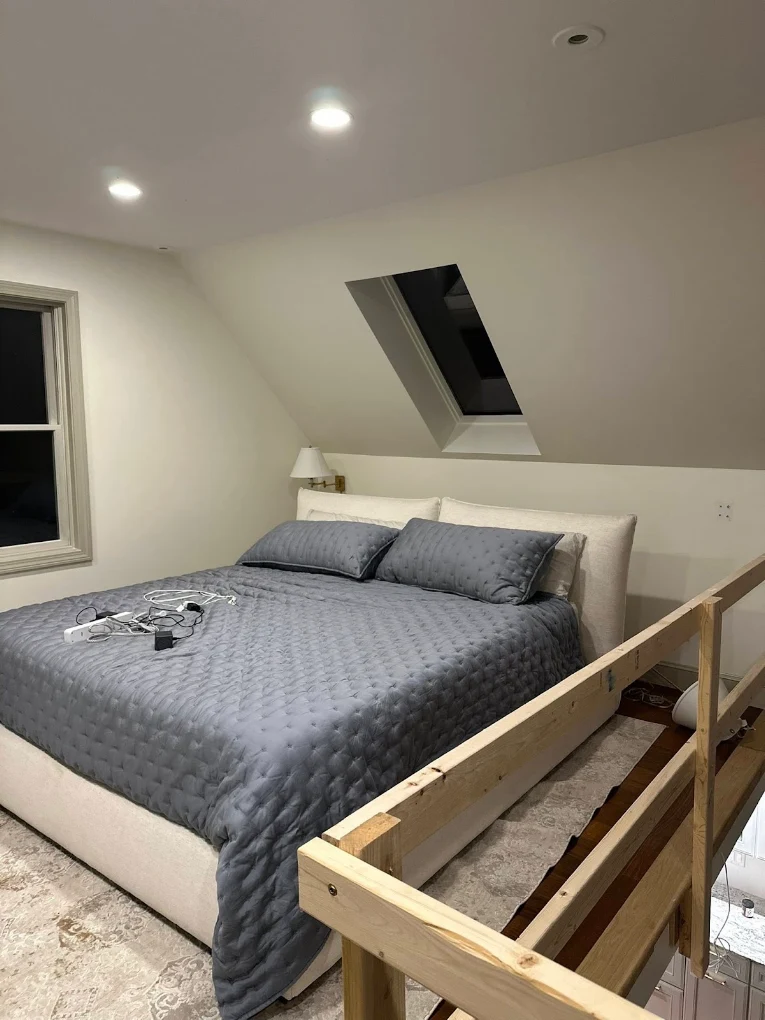 Loft bedroom with freshly painted walls and sloped ceiling