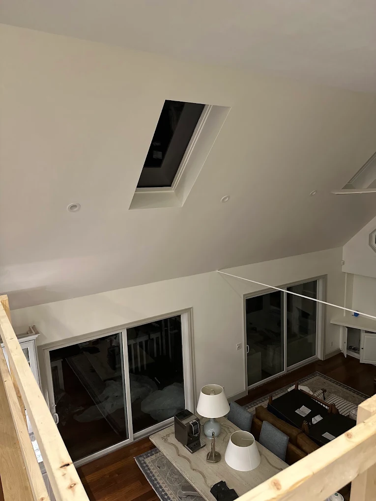 Fresh white walls and vaulted ceiling surrounding a loft living area