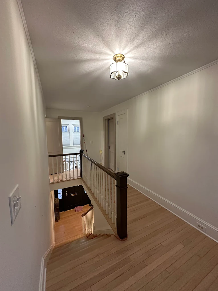 Bright stairway with freshly painted walls and crisp trim lines