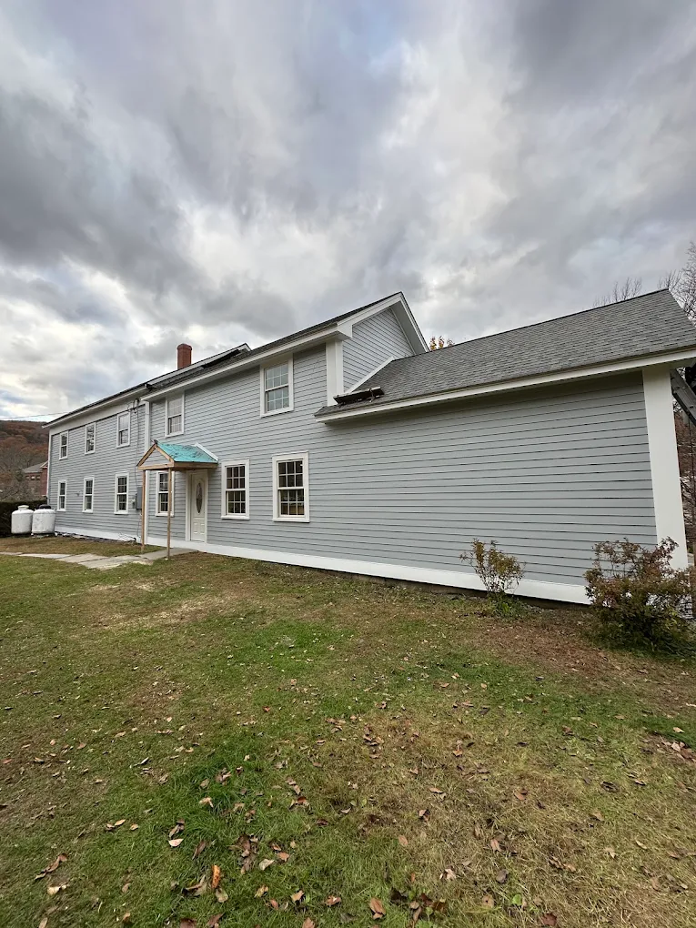 Long two-story home with new light gray exterior finish
