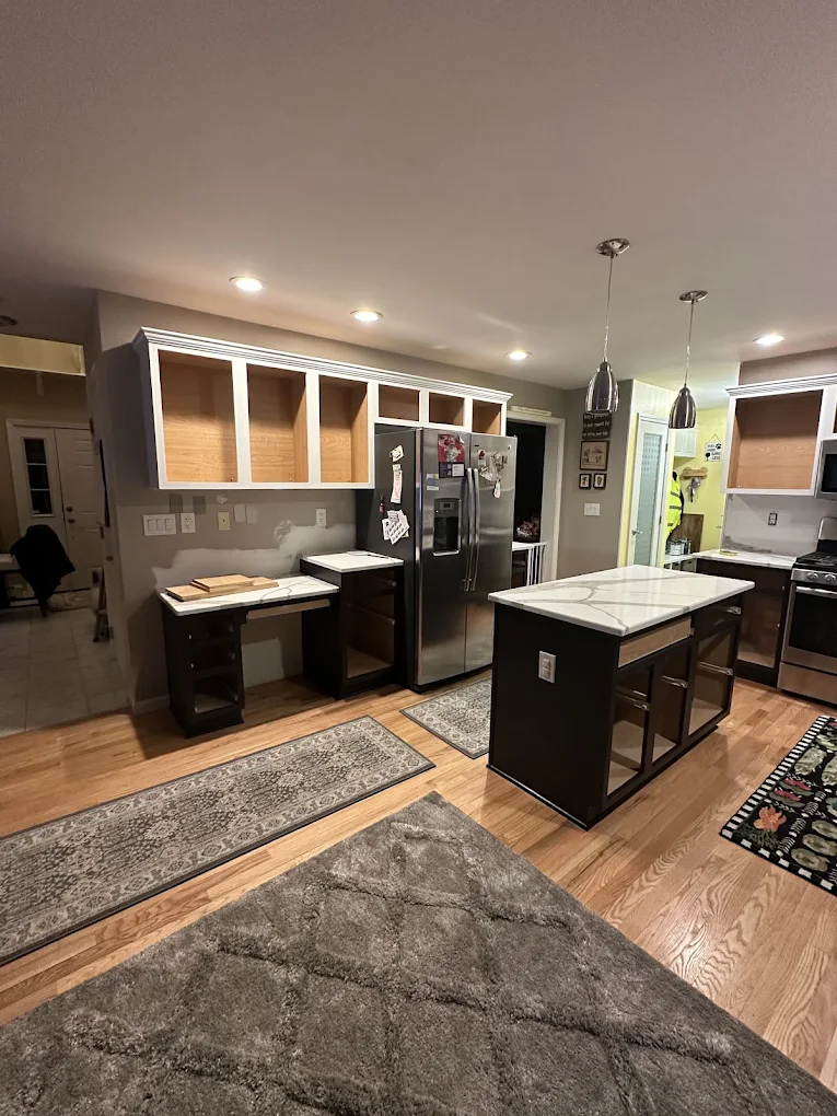 Kitchen cabinets prepared for refinishing with doors removed