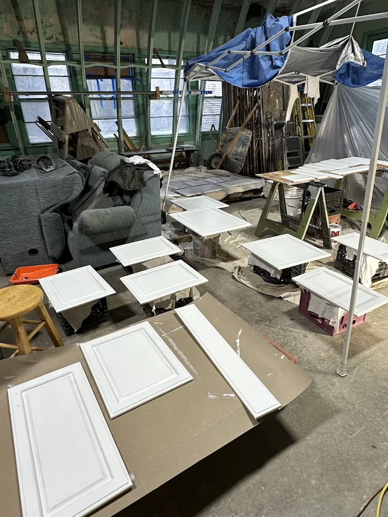 White cabinet doors laid out to dry in the shop