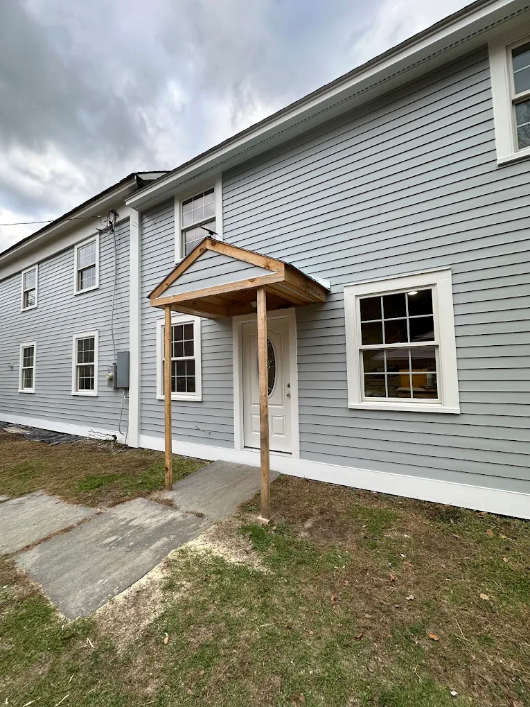 Light gray siding with fresh white trim on a long two-story home