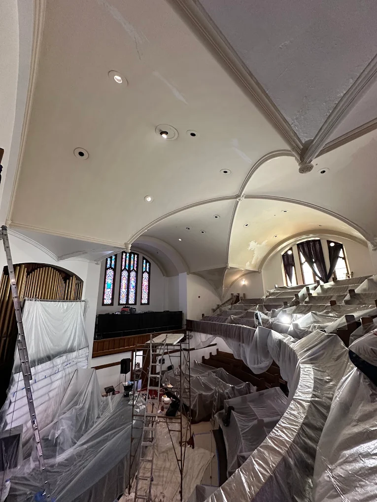 Scaffolding and covered pews during a church ceiling project