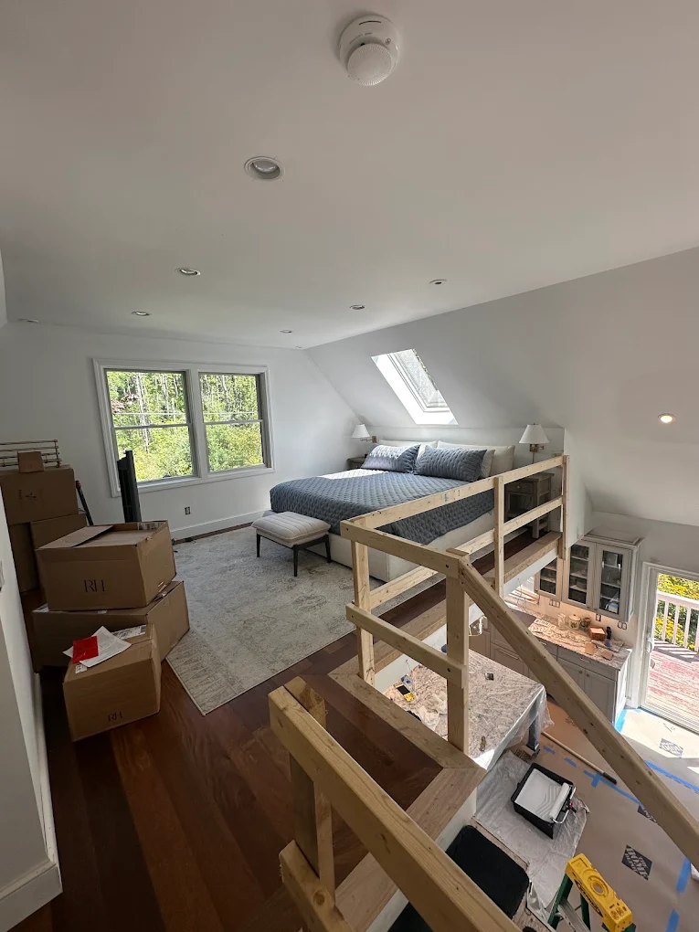 Bright loft bedroom with white walls and sloped ceiling