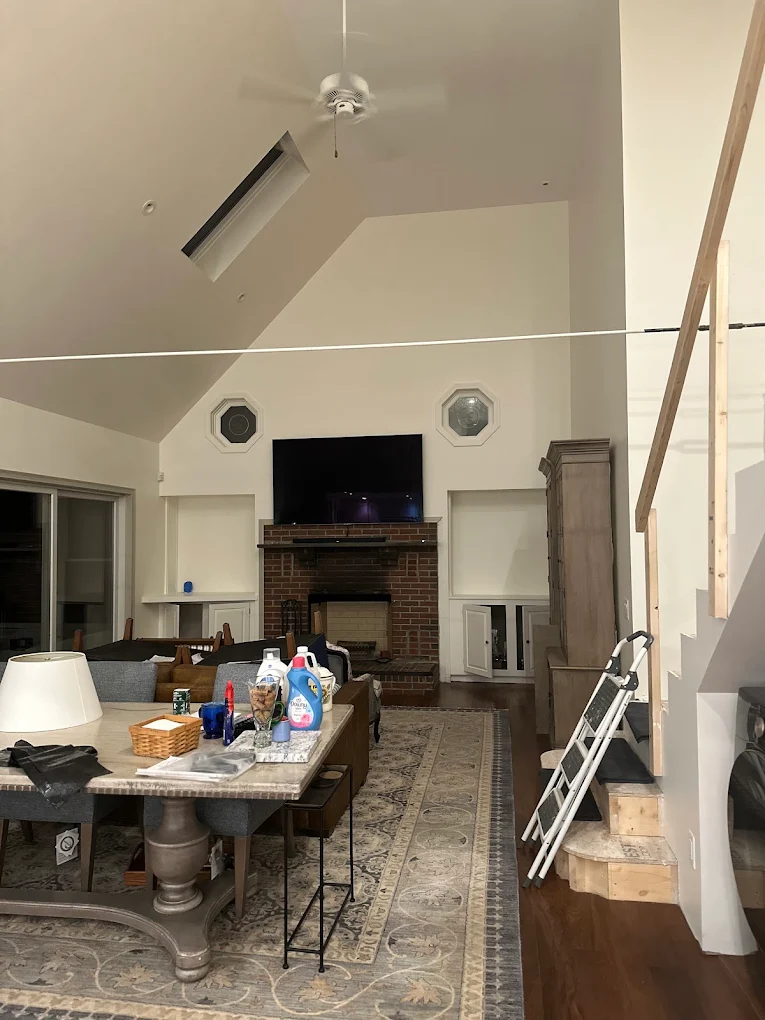 Vaulted living room with clean white walls and ceiling