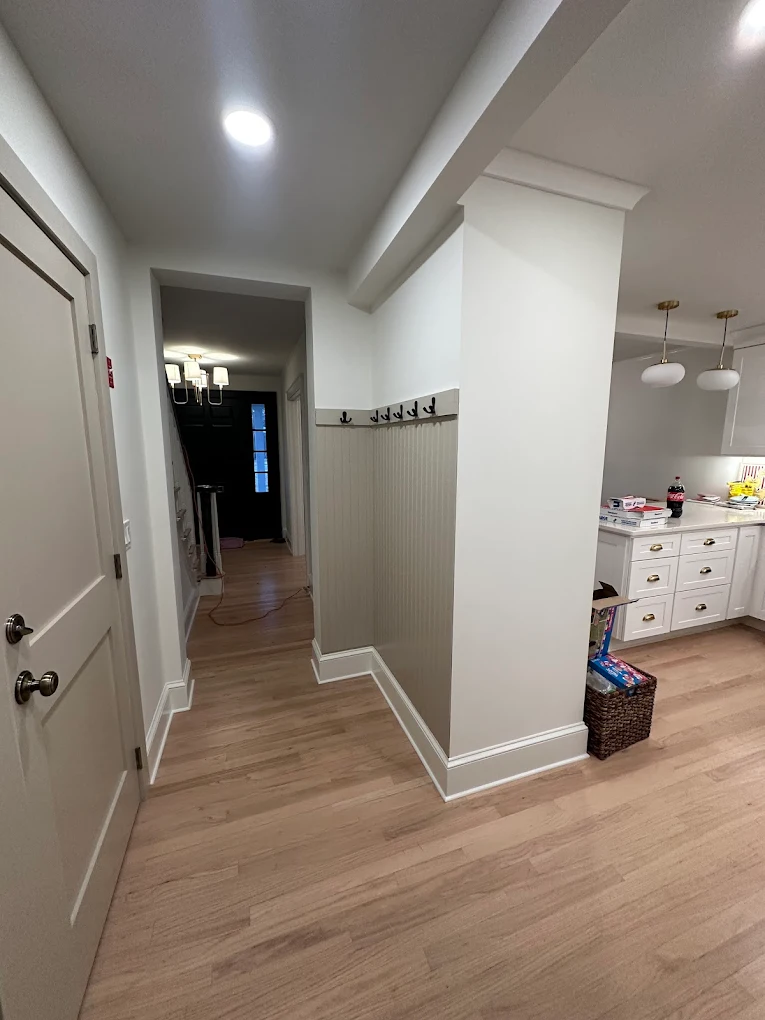Hallway with white walls, trim and beadboard wainscoting