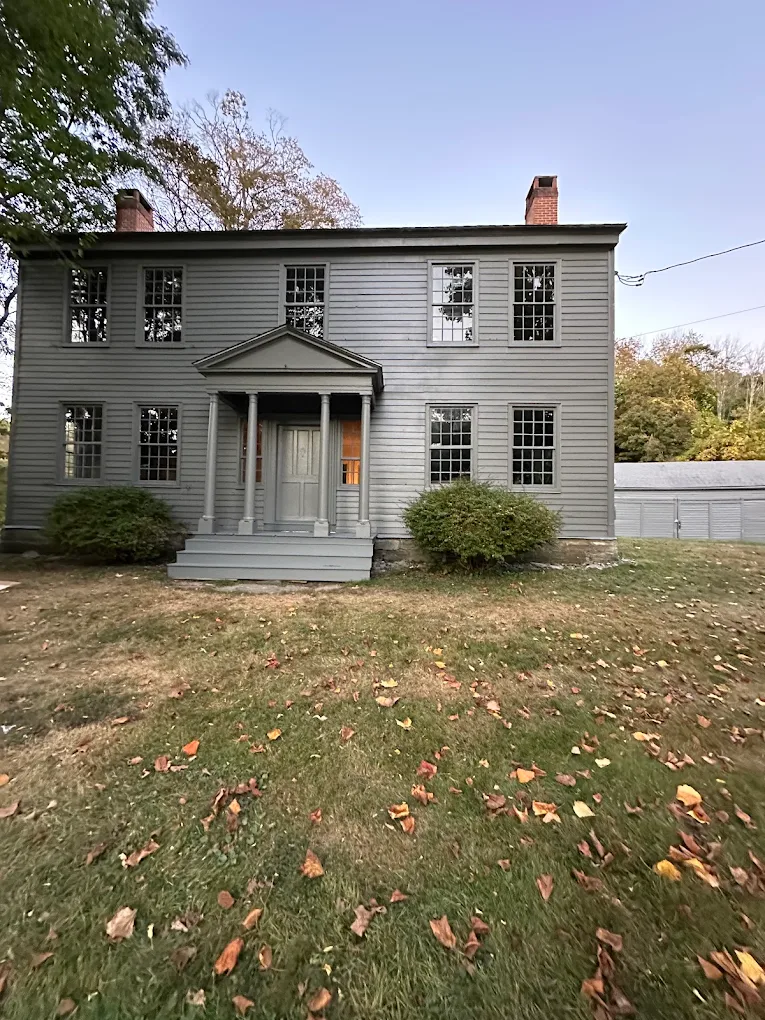 Careful exterior work on a historic gray Colonial home