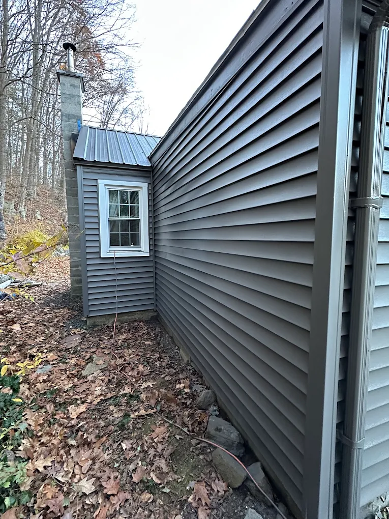 Smooth, even coverage on freshly painted gray siding